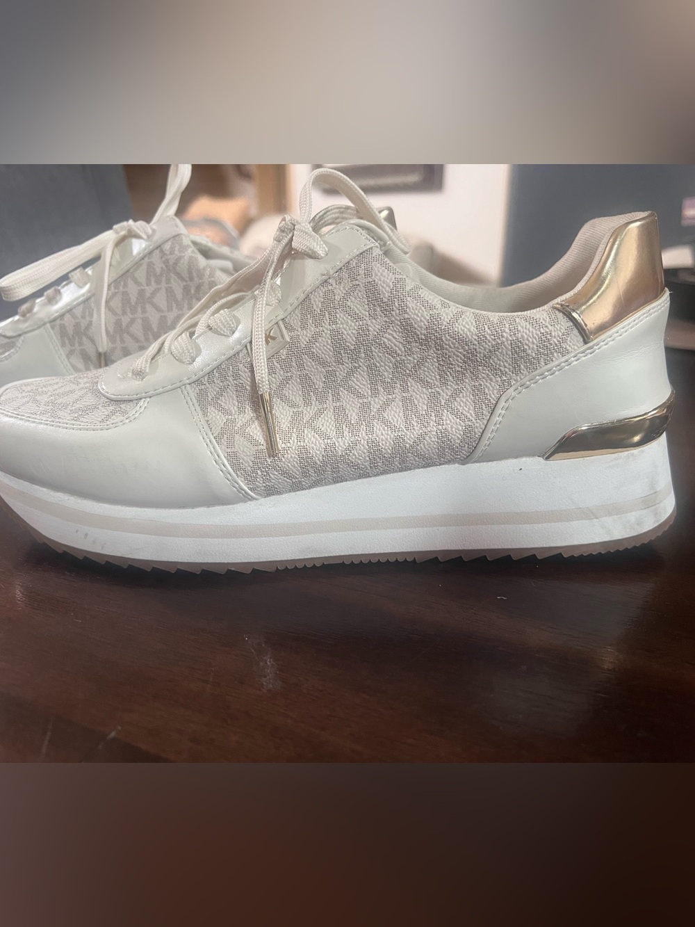 Michael Kor’s Beige MK with Gold accents Sneaker